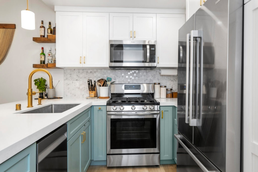 Inspiration for a small traditional galley eat-in kitchen in Dallas with an undermount sink, shaker cabinets, green cabinets, quartz benchtops, grey splashback, mosaic tile splashback, stainless steel appliances, laminate floors, a peninsula, brown floor and white benchtop.