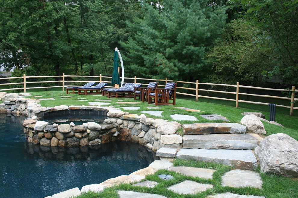 Country backyard pool in New York with a hot tub.