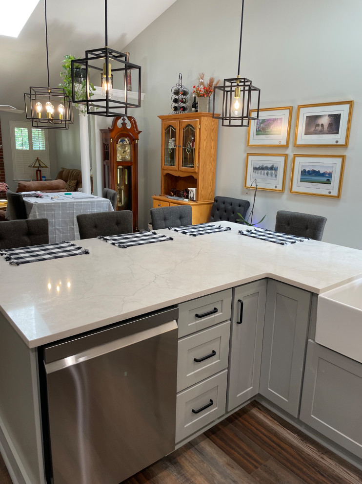 Mid-sized transitional u-shaped vinyl floor and brown floor eat-in kitchen photo with shaker cabinets, white cabinets, quartz countertops, gray backsplash, subway tile backsplash, stainless steel appliances, no island and white countertops