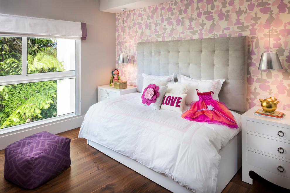 Mid-sized contemporary kids' bedroom in Miami with multi-coloured walls and dark hardwood floors for girls.