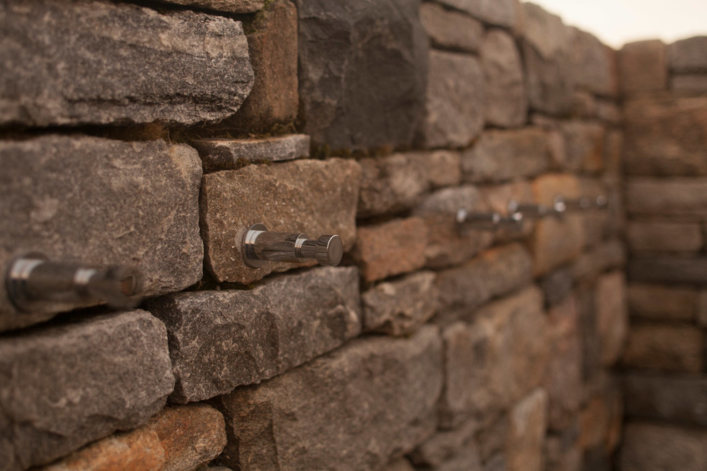 Inspiration for a mid-sized rustic backyard stone outdoor patio shower remodel in New York with no cover