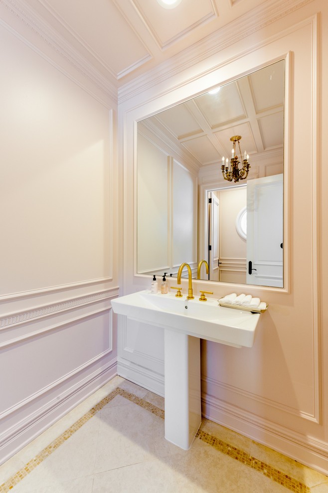 This is an example of a small transitional powder room in Los Angeles with a pedestal sink and pink walls.