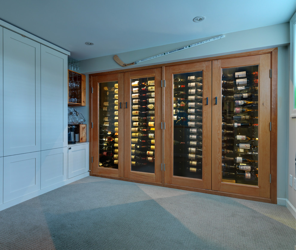 Mid-sized transitional wine cellar in Vancouver with display racks, grey floor and carpet.