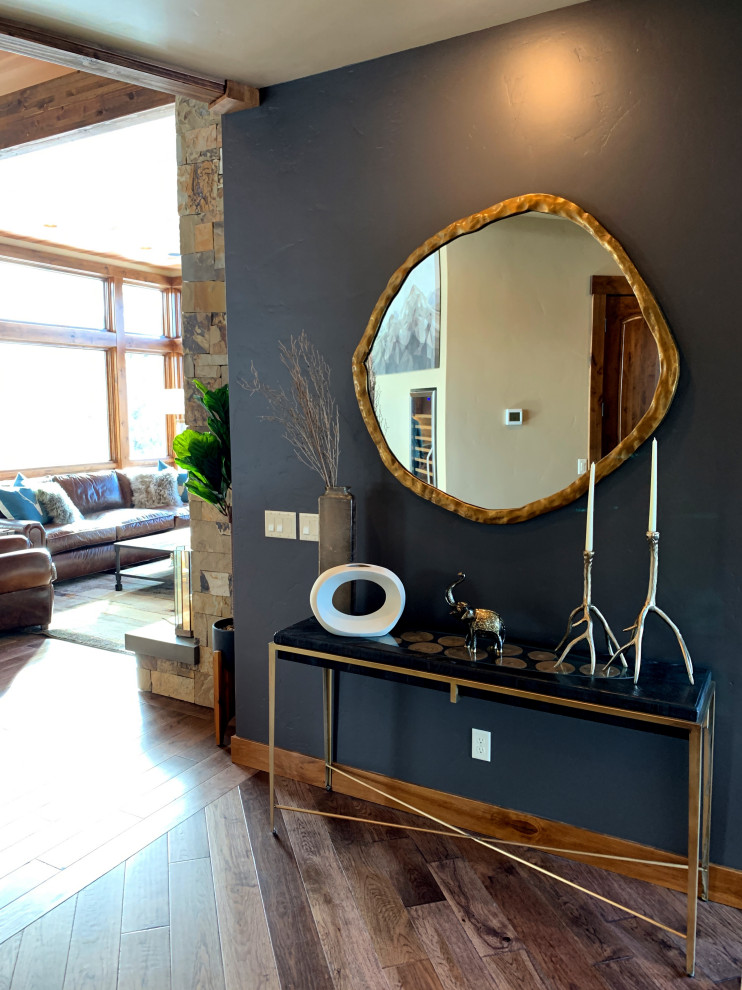 Large mountain style dark wood floor and brown floor hallway photo with gray walls