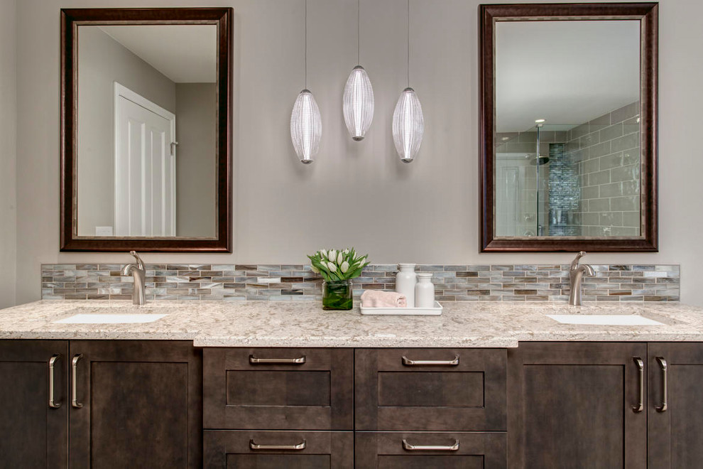 Example of a large transitional master multicolored tile and matchstick tile pebble tile floor freestanding bathtub design in Seattle with shaker cabinets, dark wood cabinets, a two-piece toilet, beige walls, an undermount sink and quartz countertops