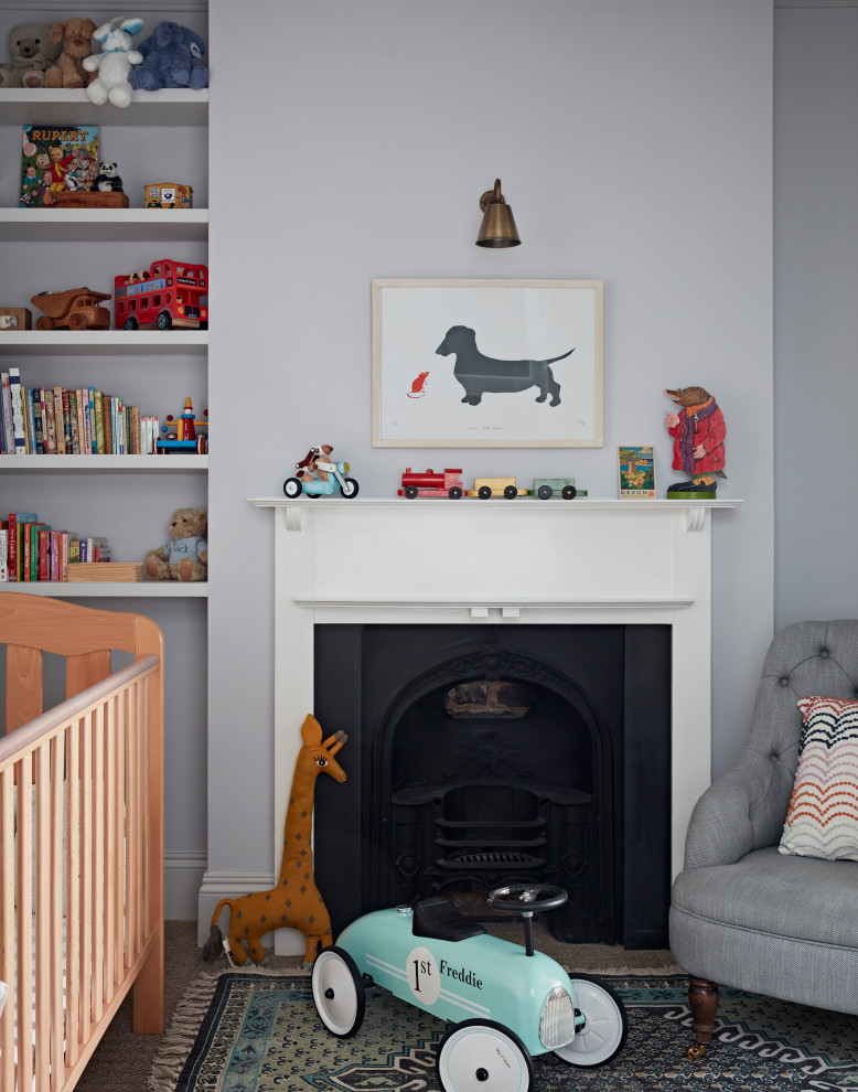 Design ideas for a mid-sized transitional nursery for boys in London with grey walls and carpet.