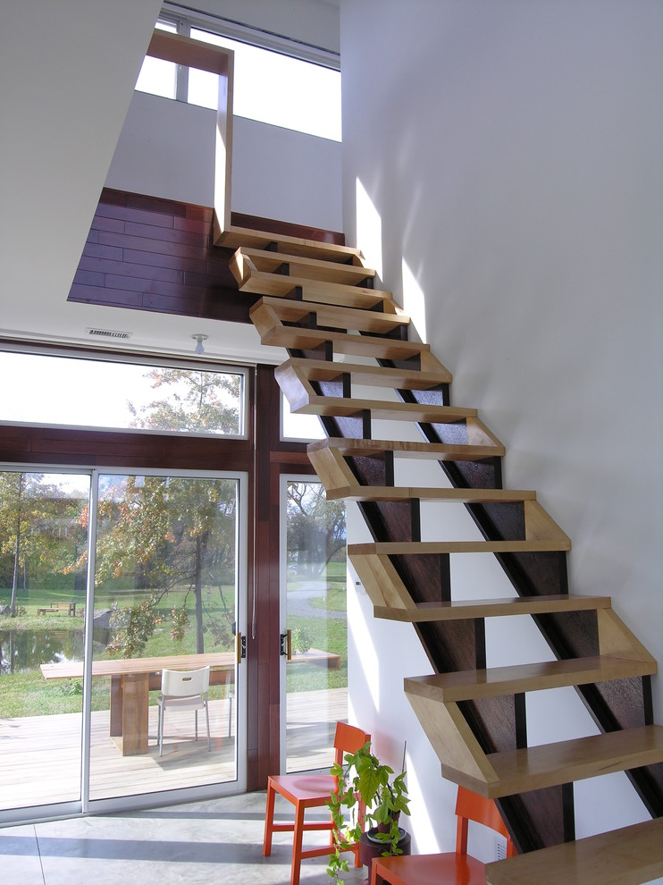 Modern wood staircase in New York with open risers.
