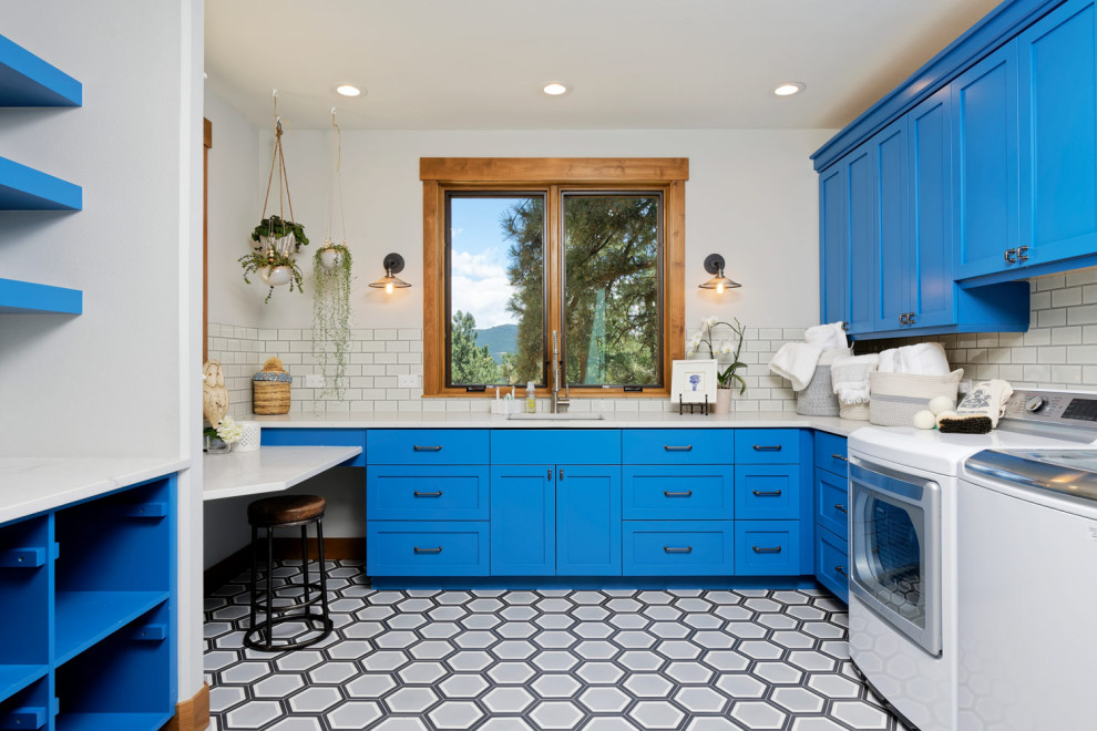 Inspiration for a medium sized traditional galley utility room in Other with blue cabinets, a side by side washer and dryer and white worktops.