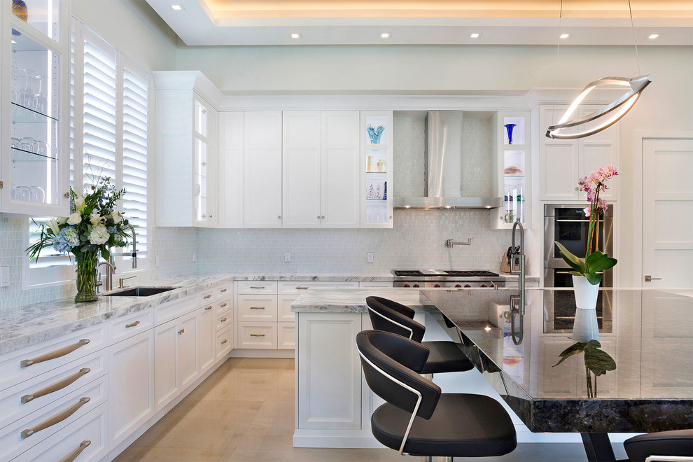 Example of a mid-sized transitional l-shaped ceramic tile and beige floor open concept kitchen design in Miami with an undermount sink, recessed-panel cabinets, white cabinets, marble countertops, multicolored backsplash, mosaic tile backsplash, stainless steel appliances, an island and multicolored countertops
