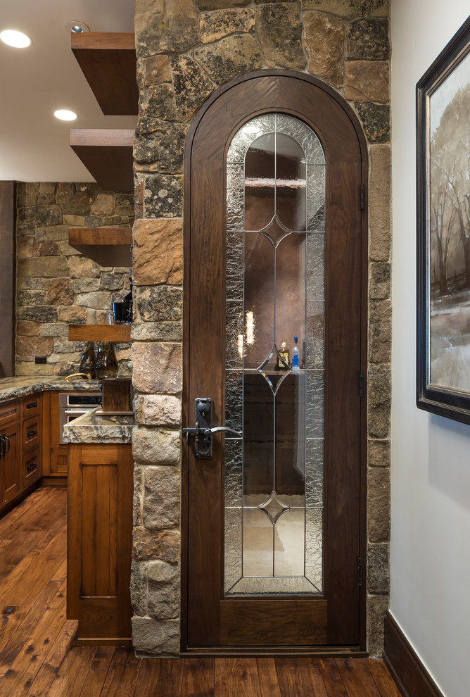 This is an example of a small country wine cellar in Salt Lake City with travertine floors and beige floor.