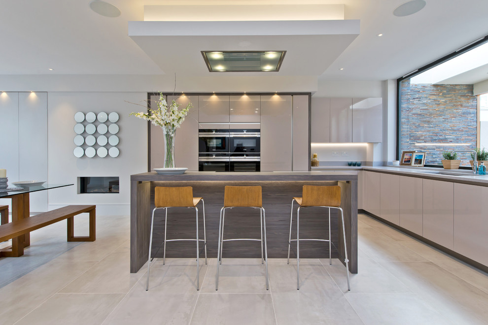 Inspiration for a mid-sized contemporary l-shaped eat-in kitchen in London with a double-bowl sink, flat-panel cabinets, beige cabinets, quartzite benchtops, stainless steel appliances, marble floors, with island and white floor.