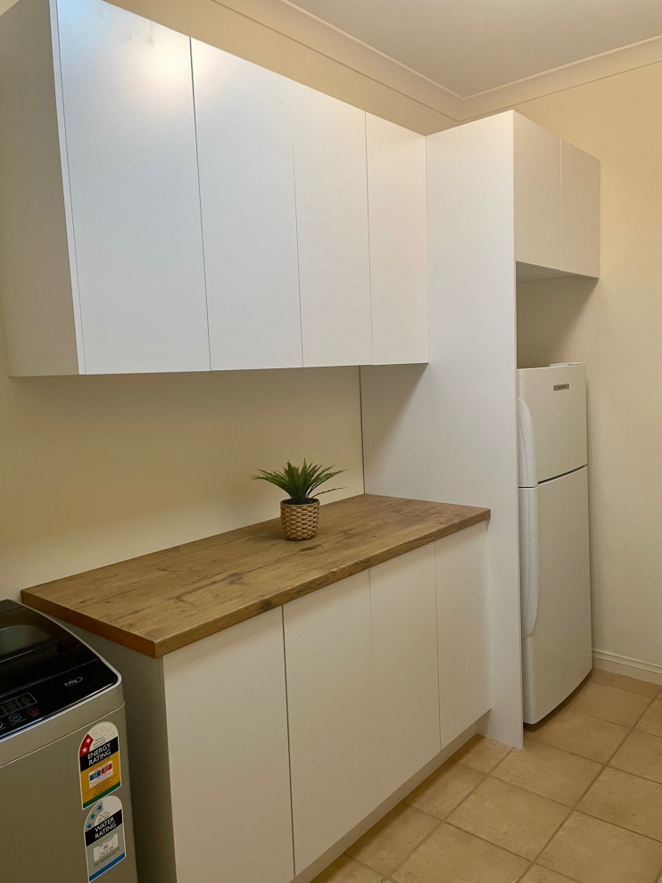 Small minimalist single-wall laundry room photo in Melbourne with flat-panel cabinets, white cabinets and laminate countertops