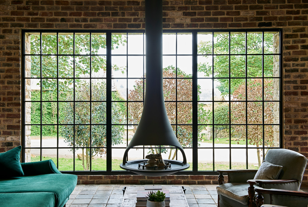 Photo of an industrial living room in Gloucestershire with a hanging fireplace.