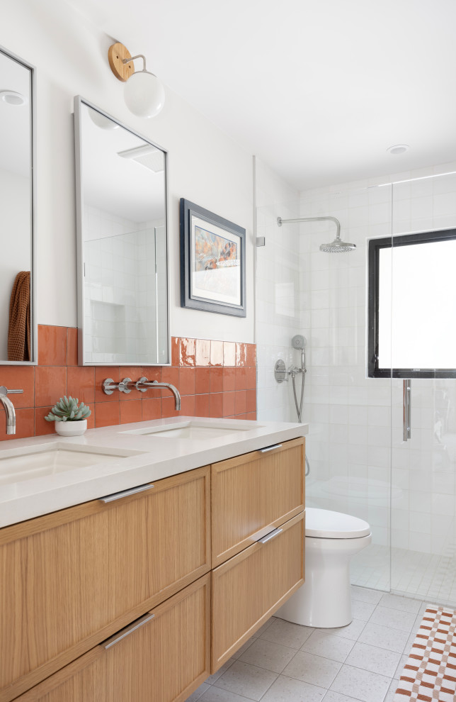 Example of a trendy orange tile and white tile gray floor and double-sink alcove shower design in Salt Lake City with shaker cabinets, medium tone wood cabinets, white walls, an undermount sink, a hinged shower door, white countertops and a floating vanity
