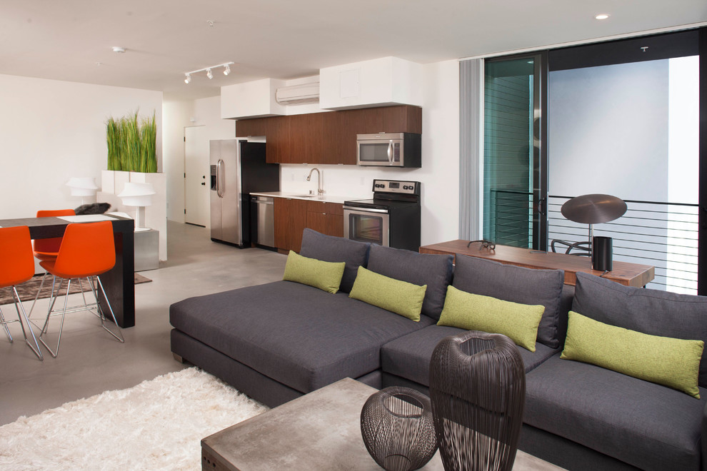 Photo of a contemporary formal open concept living room in San Diego with white walls and concrete floors.
