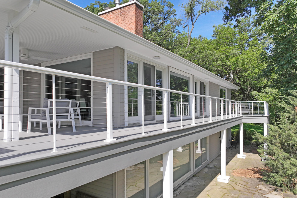 This is an example of a contemporary back first floor wire cable railing terrace in Chicago with an outdoor kitchen.