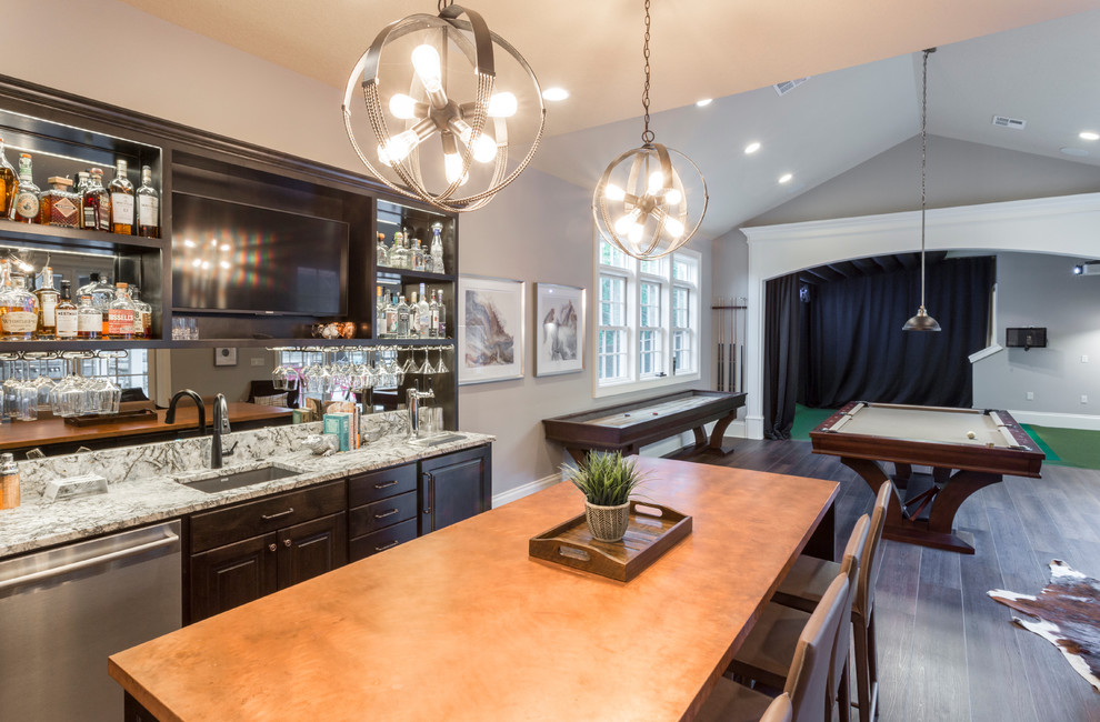 Seated home bar - huge transitional galley medium tone wood floor seated home bar idea in Portland with an undermount sink, dark wood cabinets, quartz countertops and mirror backsplash