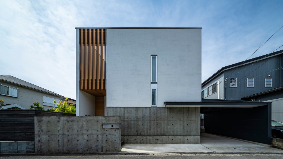 Inspiration för ett funkis grått hus, med blandad fasad och platt tak