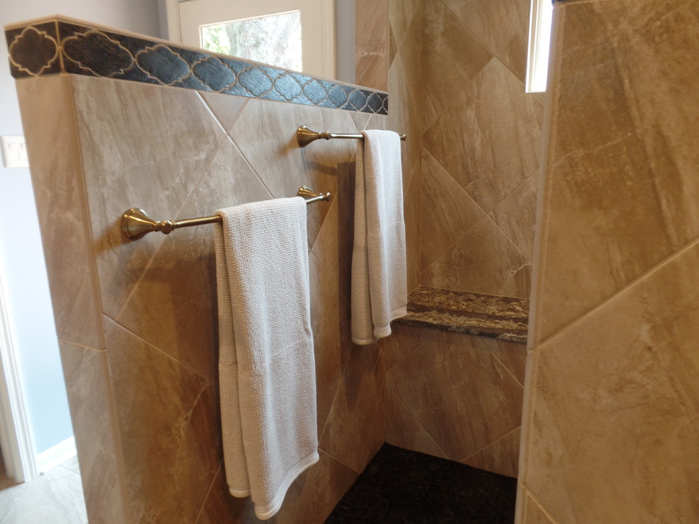 Inspiration for a large transitional master beige tile and porcelain tile porcelain tile and beige floor home design remodel with shaker cabinets, white cabinets, a two-piece toilet, blue walls, an undermount sink and quartz countertops