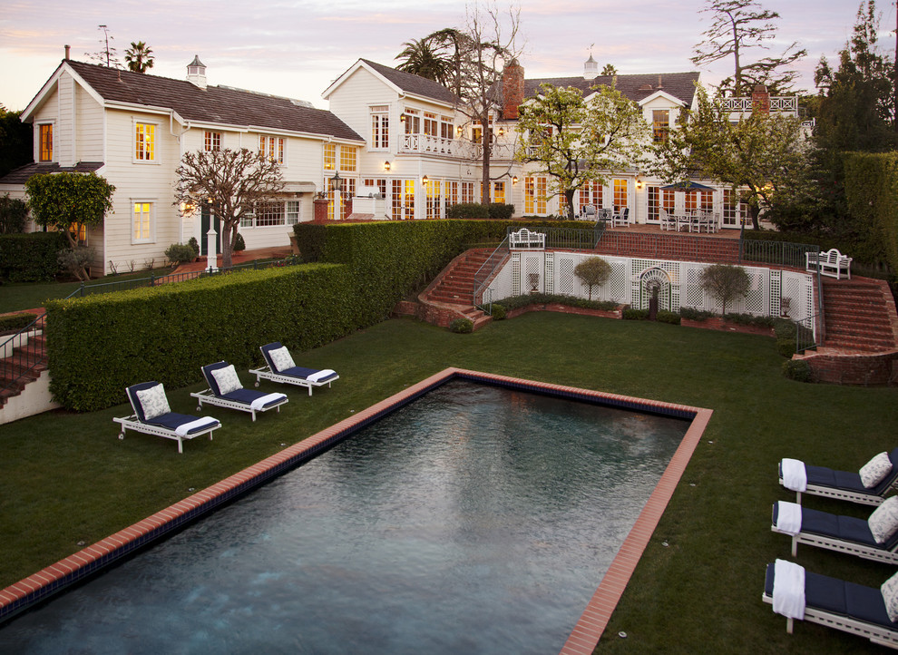 Photo of a traditional pool in Los Angeles with brick pavers.