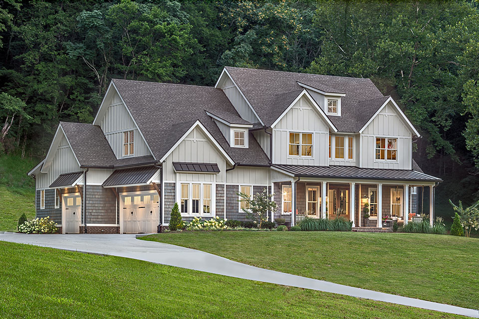 Photo of a mid-sized country two-storey grey house exterior in Nashville with wood siding, a gable roof and a shingle roof.