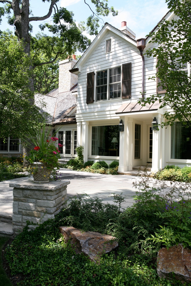 Large traditional two-storey white exterior in Chicago with mixed siding and a gable roof.