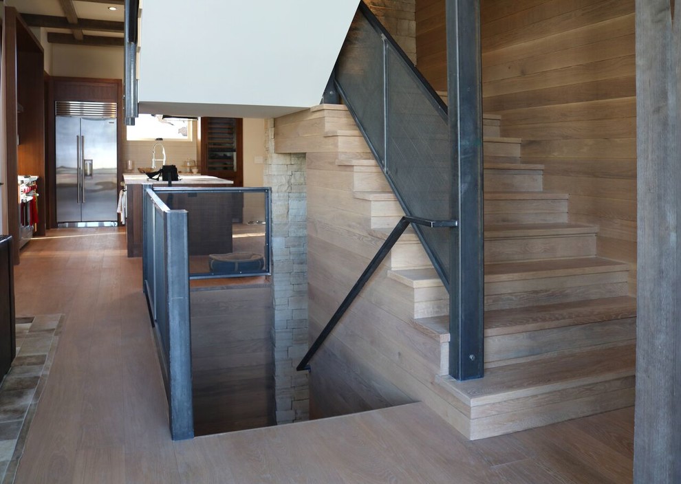 Photo of a mid-sized country wood straight staircase in Denver with wood risers and metal railing.