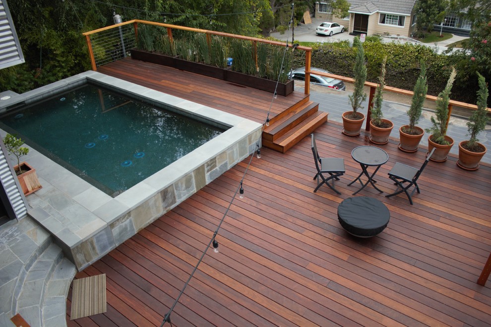 Photo of a mid-sized modern backyard deck in Los Angeles with an outdoor kitchen and a pergola.