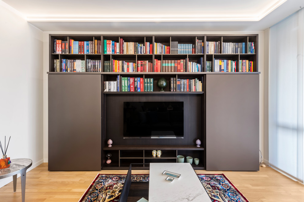 Inspiration for a large contemporary open concept living room in Milan with white walls, light hardwood floors, no fireplace, a built-in media wall, brown floor, a library and recessed.