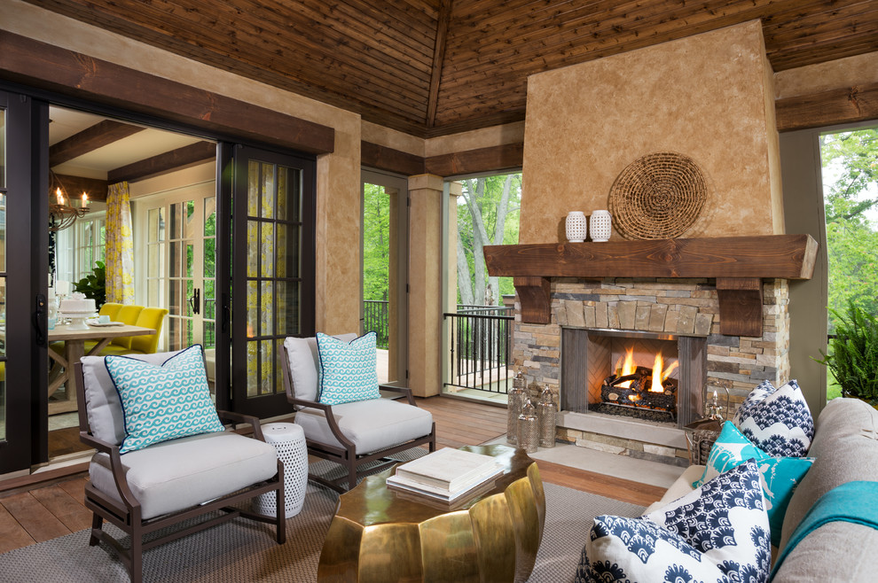 This is an example of a traditional porch design in Minneapolis with a fire pit.