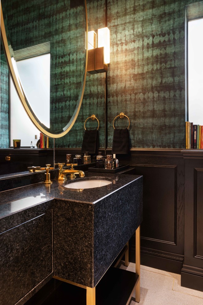 Inspiration for a contemporary powder room in London with flat-panel cabinets, black cabinets, terrazzo floors, granite benchtops and black benchtops.