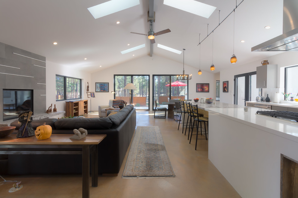 Large transitional u-shaped medium tone wood floor and brown floor open concept kitchen photo in Phoenix with an undermount sink, flat-panel cabinets, gray cabinets, solid surface countertops, white backsplash, stainless steel appliances and an island