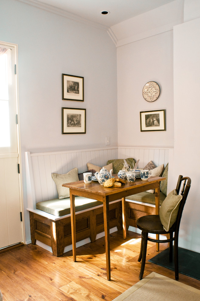 Small traditional dining room in Charleston with white walls and medium hardwood floors.