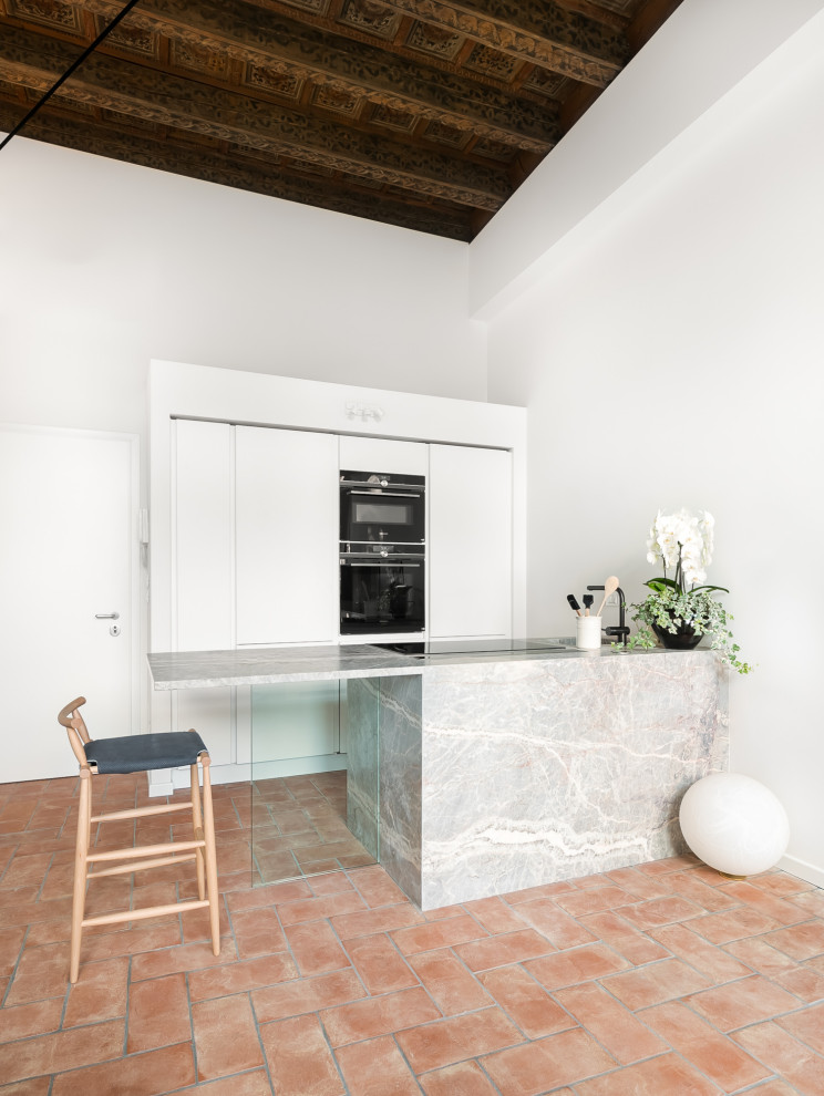 Medium sized contemporary galley open plan kitchen in Other with a submerged sink, recessed-panel cabinets, white cabinets, marble worktops, marble flooring, a breakfast bar, red floors, multicoloured worktops and a coffered ceiling.