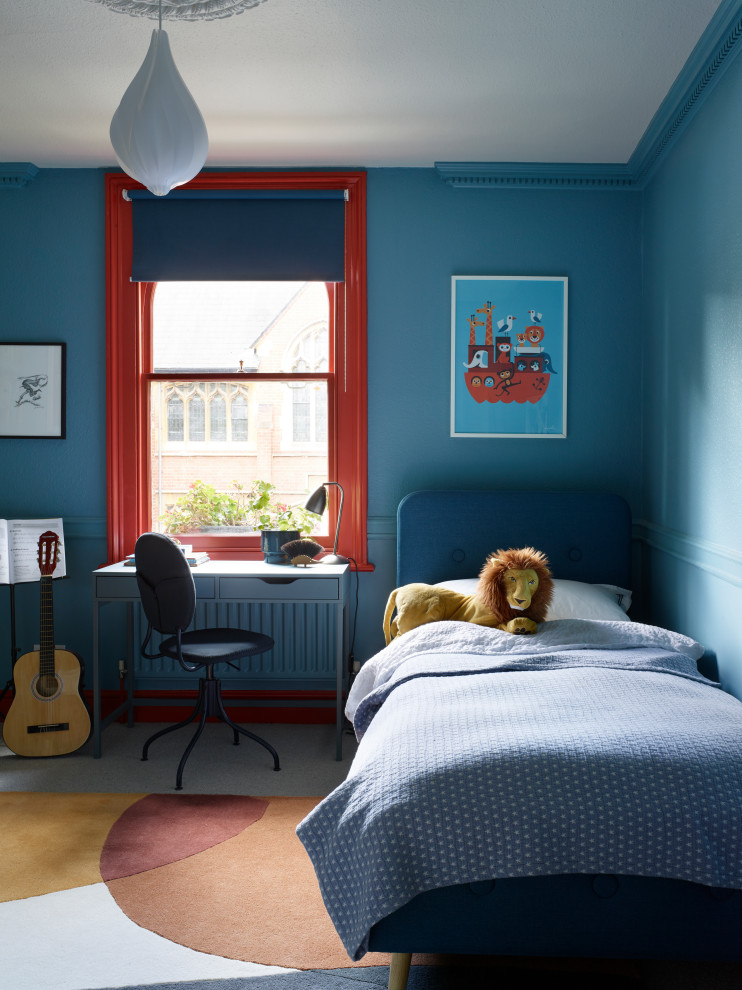 Transitional kids' room in London with blue walls.