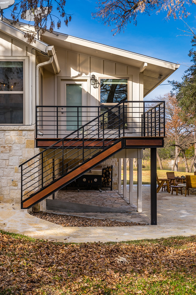 Inspiration for a mid-sized rustic one-story mixed siding house exterior remodel in Austin
