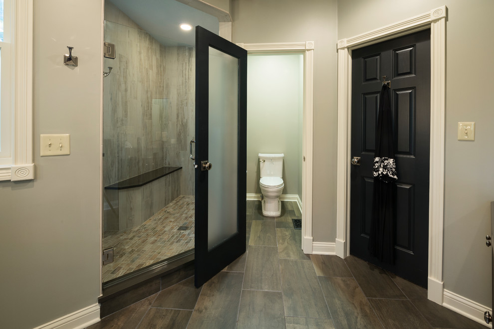 Inspiration for a large arts and crafts master wet room bathroom in Indianapolis with a two-piece toilet, brown tile, ceramic tile, grey walls and ceramic floors.