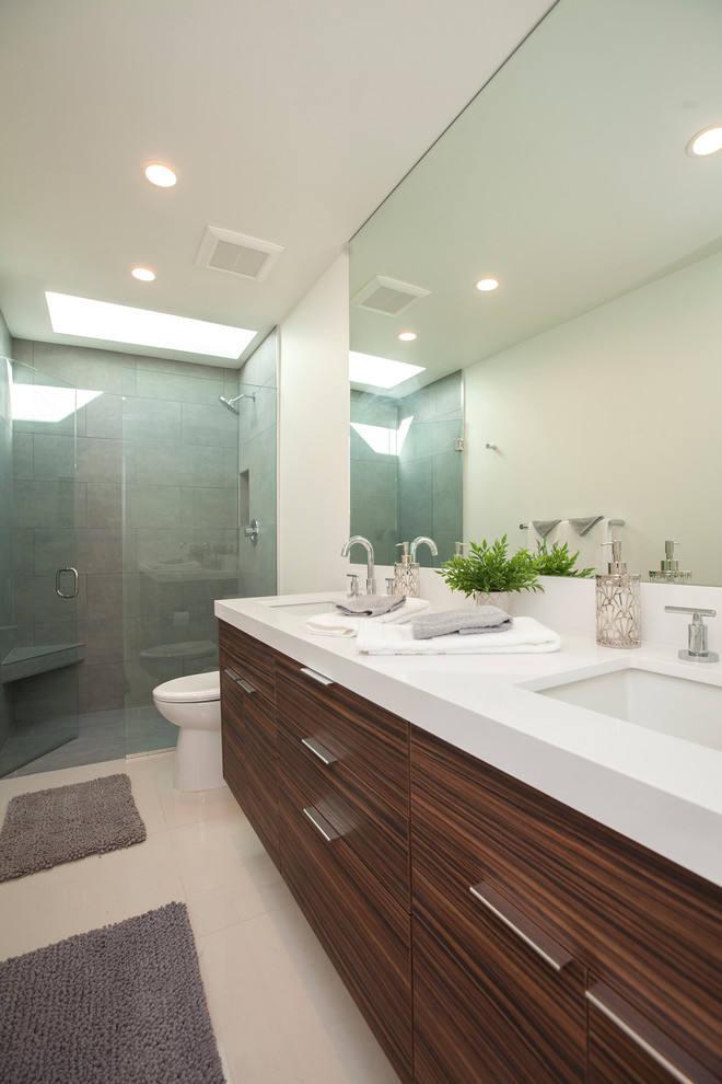 Inspiration for a large midcentury 3/4 bathroom in Los Angeles with flat-panel cabinets, brown cabinets, an alcove shower, a two-piece toilet, gray tile, porcelain tile, white walls, porcelain floors, an undermount sink, quartzite benchtops and beige floor.