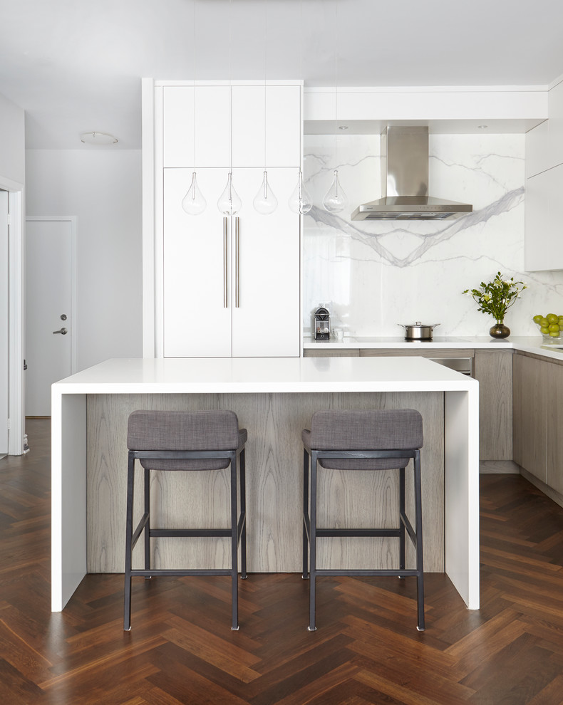 Inspiration for a mid-sized modern l-shaped open plan kitchen in Toronto with an undermount sink, flat-panel cabinets, white splashback, porcelain splashback, panelled appliances, dark hardwood floors, with island and quartz benchtops.