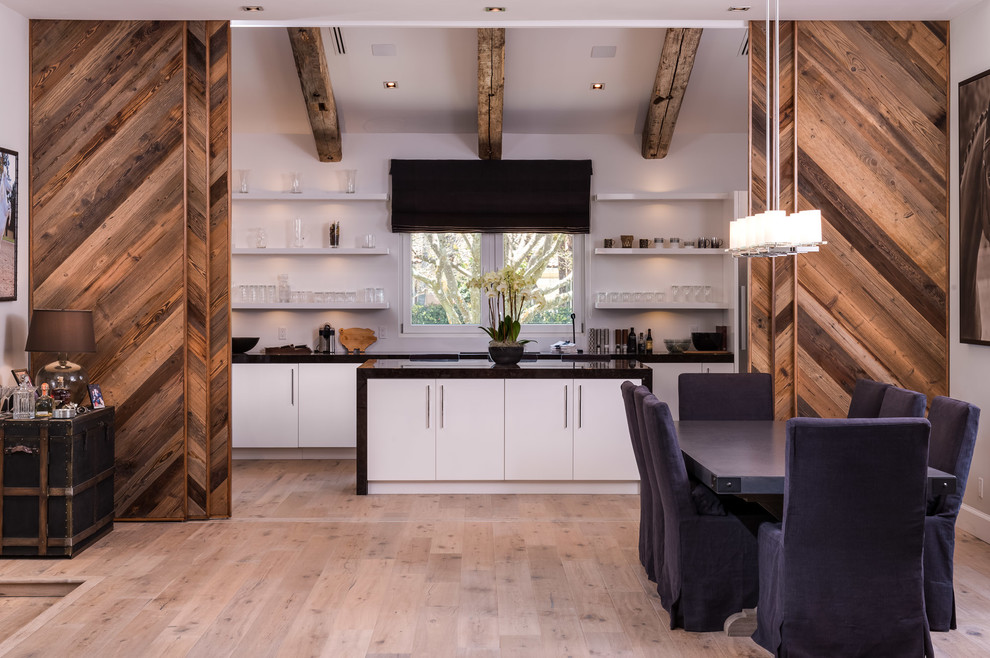 Inspiration for a huge rustic light wood floor eat-in kitchen remodel in Miami with flat-panel cabinets, white cabinets, an island, an undermount sink, granite countertops, black backsplash, mosaic tile backsplash and stainless steel appliances