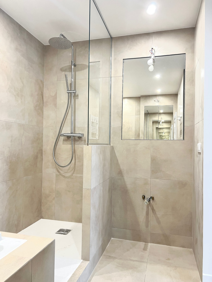 Photo of a medium sized modern shower room bathroom in Paris with beige tiles, double sinks, flat-panel cabinets, beige cabinets, a walk-in shower, a two-piece toilet, ceramic tiles, beige walls, ceramic flooring, a console sink, beige floors, an open shower, beige worktops and a freestanding vanity unit.