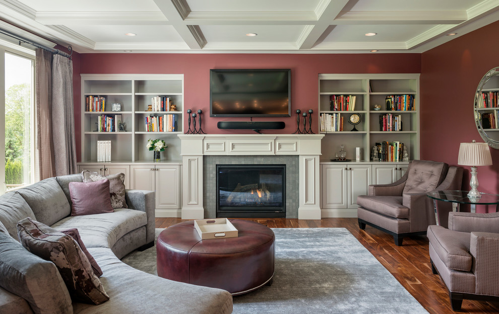 Inspiration for a traditional formal enclosed living room in Seattle with medium hardwood floors, a standard fireplace, a tile fireplace surround, a wall-mounted tv and red walls.