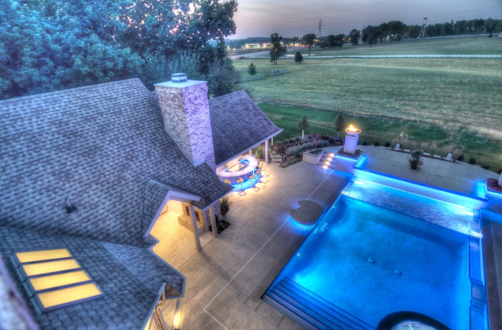 Inspiration for a large transitional backyard concrete paver and rectangular natural hot tub remodel in Cedar Rapids