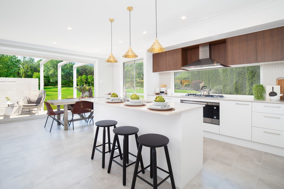 Inspiration for a contemporary eat-in kitchen in Sydney with flat-panel cabinets, white cabinets, grey splashback, with island, grey floor and grey benchtop.