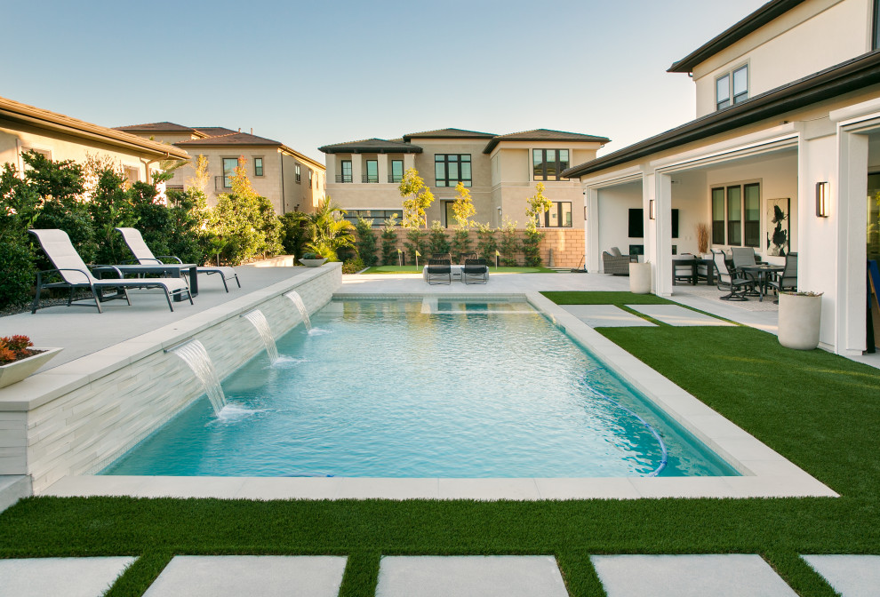Photo of a large classic back rectangular swimming pool in San Diego with with pool landscaping and tiled flooring.