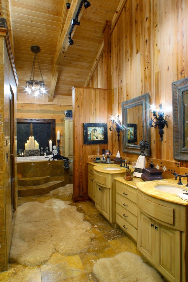 Inspiration for a large country master bathroom in Other with raised-panel cabinets, distressed cabinets, a drop-in tub, brown tile, ceramic tile, brown walls, ceramic floors, a drop-in sink and marble benchtops.