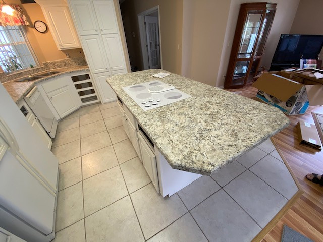 Inspiration for a mid-sized u-shaped eat-in kitchen remodel with a double-bowl sink, raised-panel cabinets, white cabinets, laminate countertops, an island and white countertops