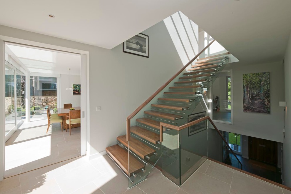 This is an example of a large contemporary wood straight staircase in Edinburgh with open risers.