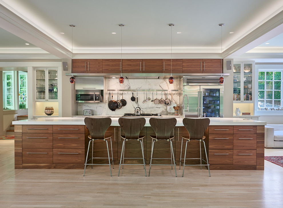 Design ideas for a contemporary galley kitchen in DC Metro with flat-panel cabinets, dark wood cabinets, white splashback, stainless steel appliances, light hardwood floors, with island and beige floor.