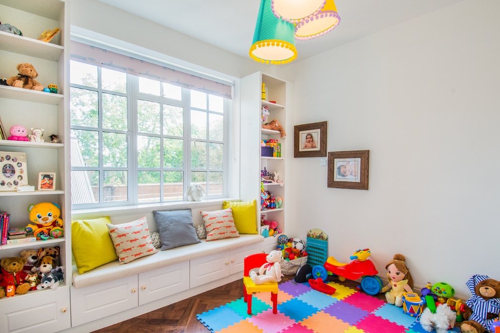 Mid-sized traditional gender-neutral kids' room in London with white walls, dark hardwood floors and brown floor.